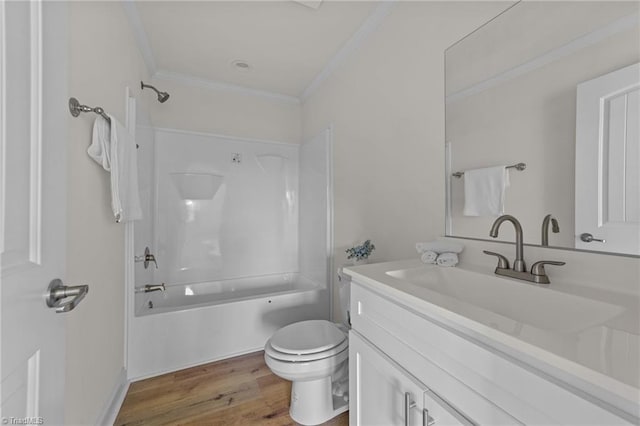 full bathroom with toilet, wood finished floors,  shower combination, crown molding, and vanity