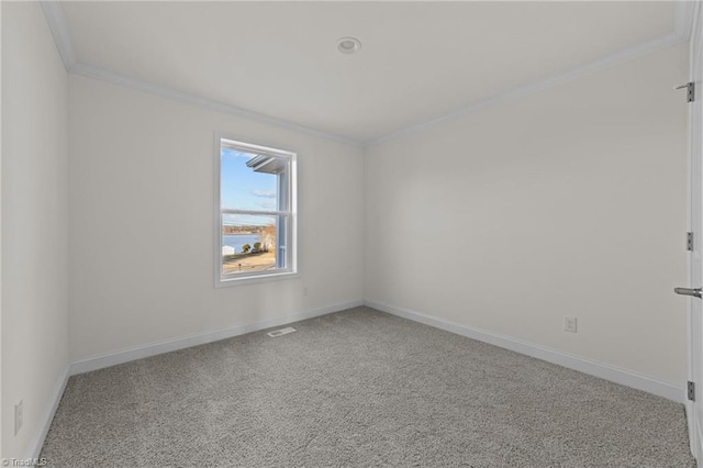 spare room featuring visible vents, baseboards, carpet, and ornamental molding