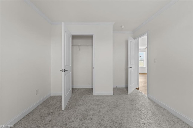 unfurnished bedroom featuring baseboards, carpet floors, a closet, and ornamental molding