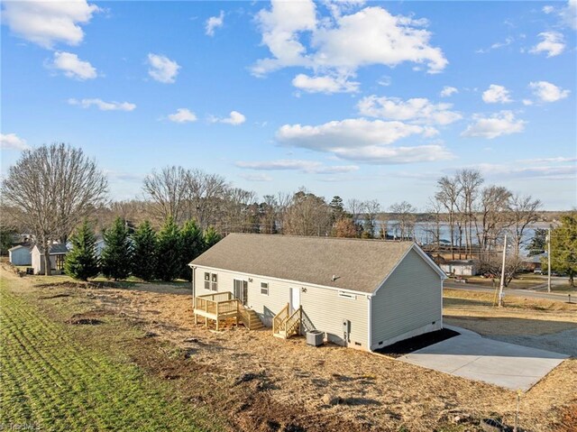 view of side of property with central AC unit and crawl space