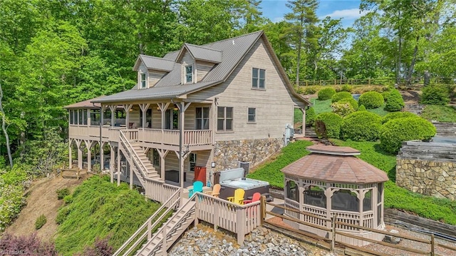 883 Wagon Ridge Ln, Ferguson, NC 28624 - back of house with a hot tub, stairway, a gazebo, a deck, and view of scattered trees