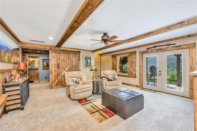 883 Wagon Ridge Ln, Ferguson, NC 28624 - living room featuring a barn door, carpet flooring, beamed ceiling, french doors, and a ceiling fan