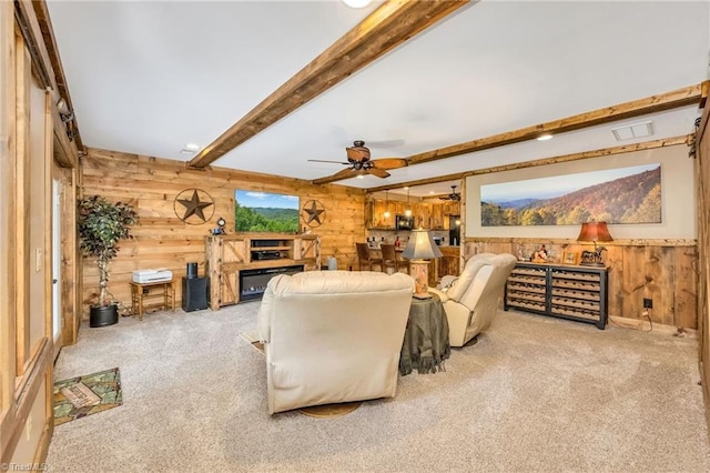 883 Wagon Ridge Ln, Ferguson, NC 28624 - carpeted living area featuring wood walls, beamed ceiling, and ceiling fan