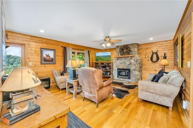 883 Wagon Ridge Ln, Ferguson, NC 28624 - living area with a ceiling fan, wood finished floors, a stone fireplace, wood walls, and recessed lighting