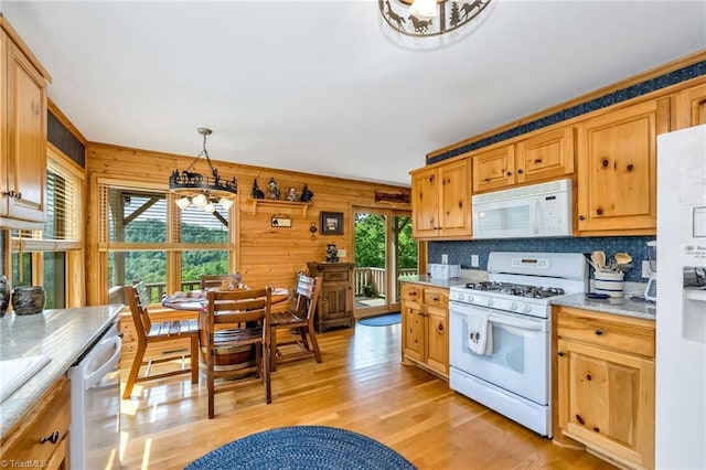 883 Wagon Ridge Ln, Ferguson, NC 28624 - kitchen with white appliances, a chandelier, light wood finished floors, light countertops, and wooden walls