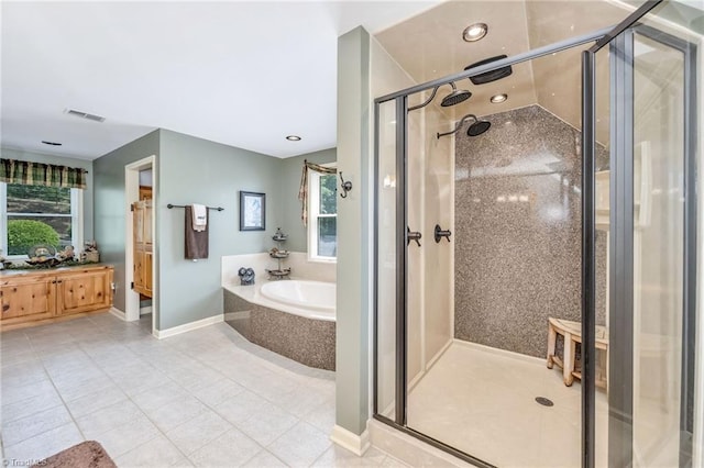 883 Wagon Ridge Ln, Ferguson, NC 28624 - bathroom featuring tile patterned floors, a stall shower, a garden tub, vanity, and baseboards