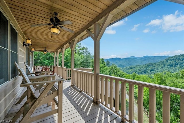 883 Wagon Ridge Ln, Ferguson, NC 28624 - wooden terrace with ceiling fan, a mountain view, and a wooded view