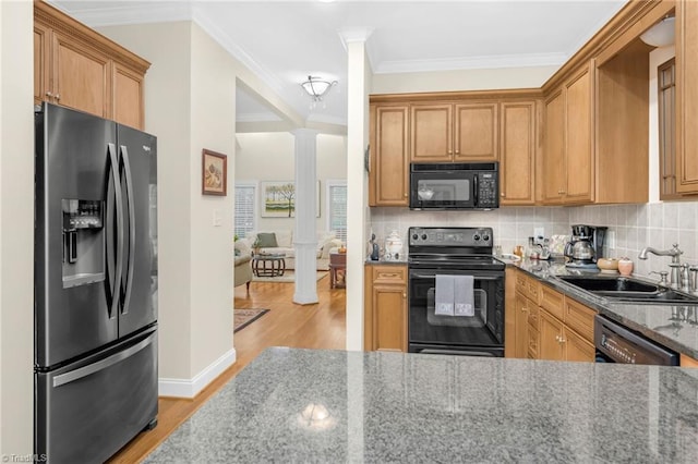 kitchen featuring crown molding, sink, black appliances, stone counters, and light hardwood / wood-style floors