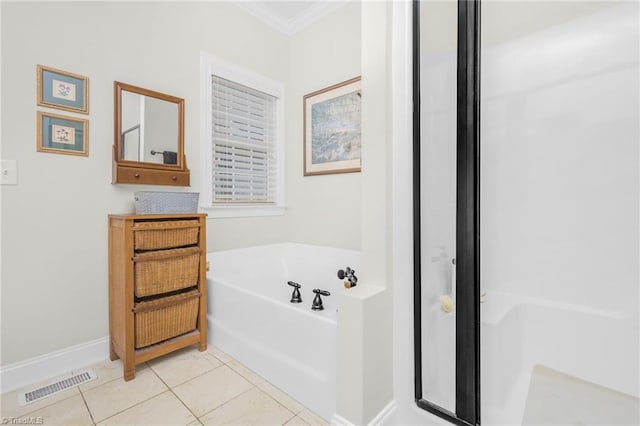 bathroom featuring tile patterned floors, a bathtub, and ornamental molding