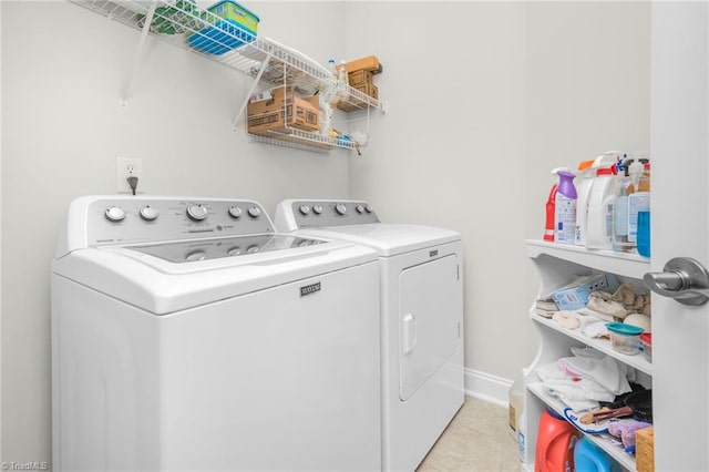 clothes washing area featuring light tile patterned floors and independent washer and dryer