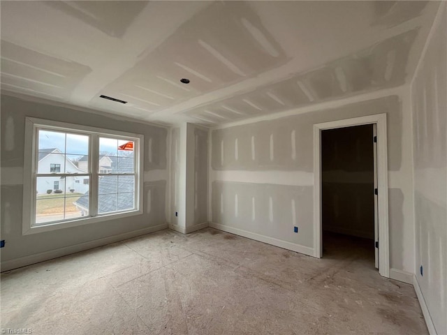 unfurnished room featuring baseboards and visible vents