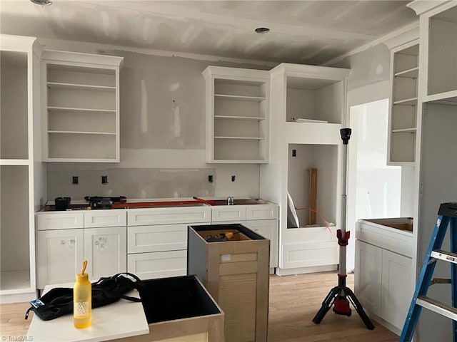 kitchen with white cabinets, light wood-style floors, and open shelves