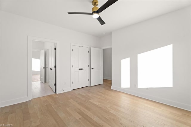 unfurnished bedroom featuring ceiling fan and light wood-type flooring