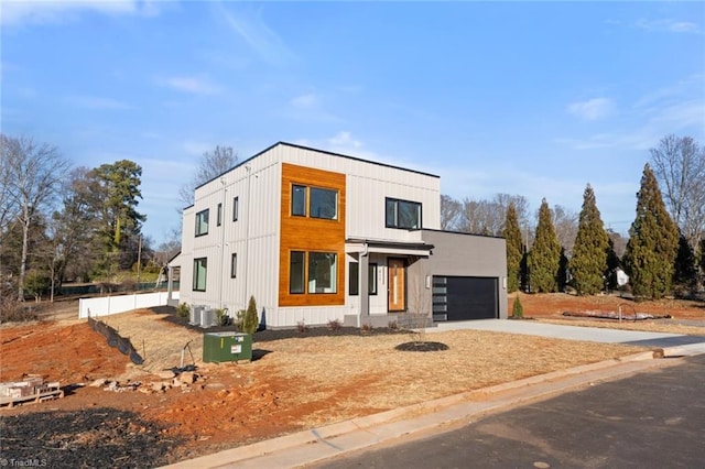 contemporary home with a garage and central AC unit