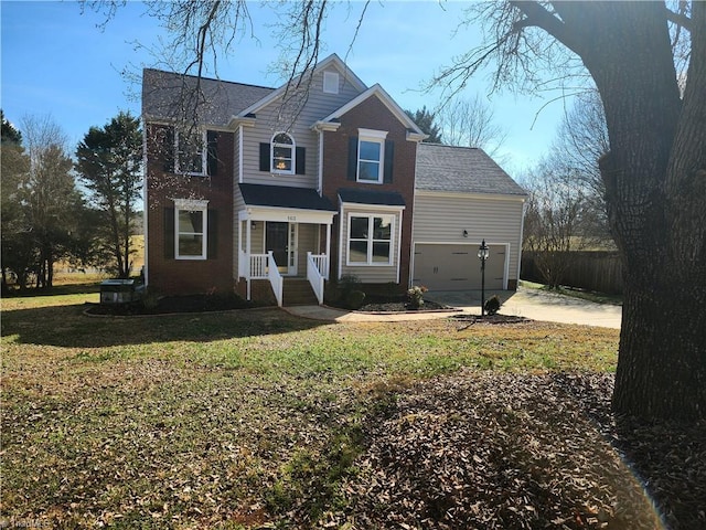 traditional home with an attached garage, driveway, a front yard, and fence