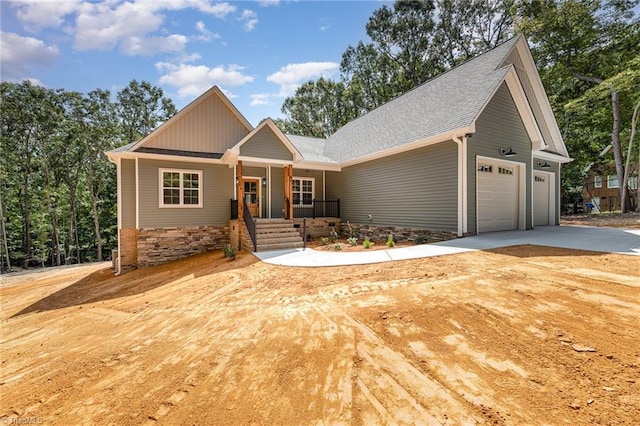 craftsman inspired home with covered porch and a garage