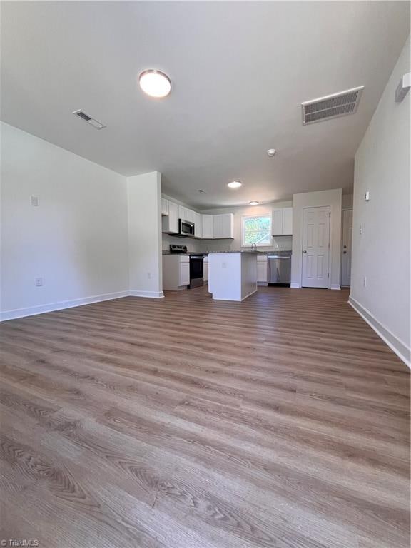 unfurnished living room featuring light hardwood / wood-style flooring