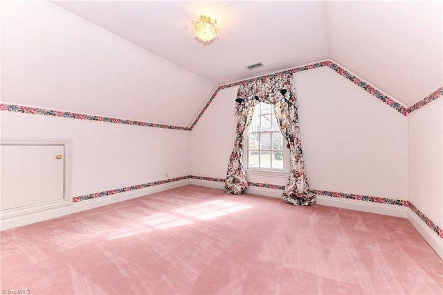 bonus room with carpet flooring and vaulted ceiling