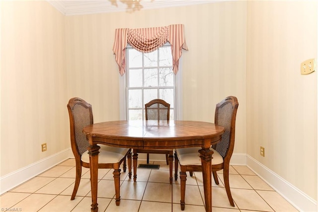 dining area with ornamental molding and light tile patterned floors