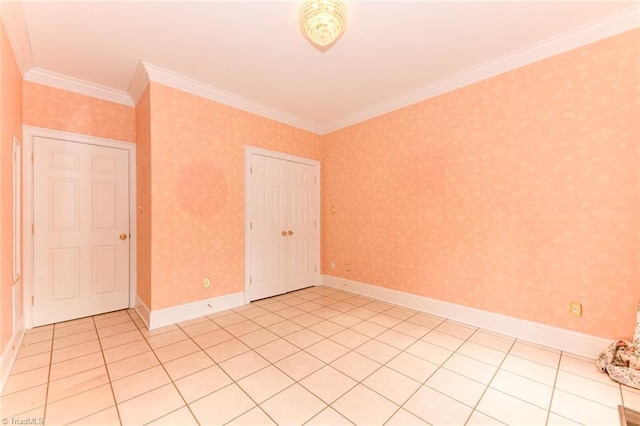 tiled spare room featuring crown molding