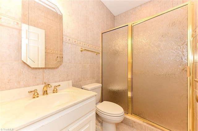 bathroom featuring toilet, tile walls, vanity, and walk in shower