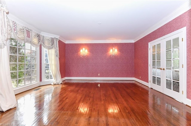 spare room with french doors, ornamental molding, and hardwood / wood-style flooring