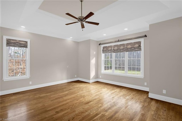 spare room featuring recessed lighting, ceiling fan, baseboards, and wood finished floors