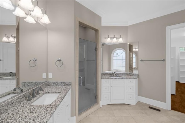 full bath with ornamental molding, a sink, visible vents, and a shower stall