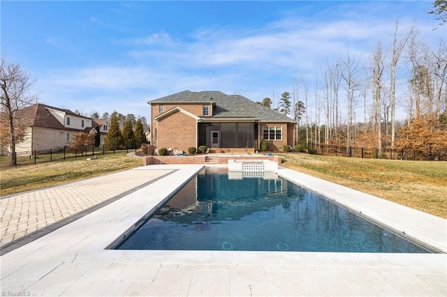 view of pool featuring a lawn, fence, and a fenced in pool