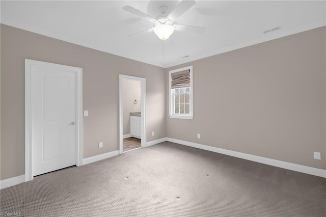 unfurnished bedroom featuring carpet floors, connected bathroom, visible vents, and baseboards