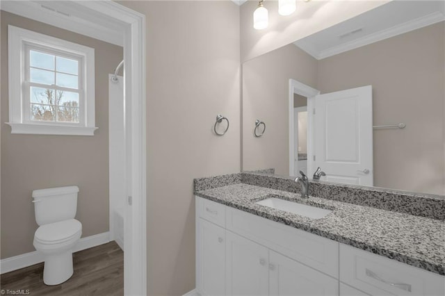 full bathroom with crown molding, toilet, vanity, wood finished floors, and baseboards