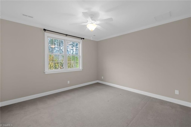 unfurnished room with carpet floors, baseboards, visible vents, and ceiling fan