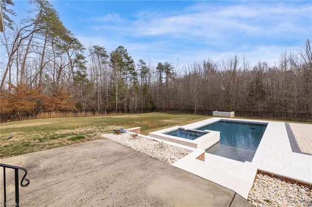 pool with an in ground hot tub, a lawn, a patio area, and a fenced backyard