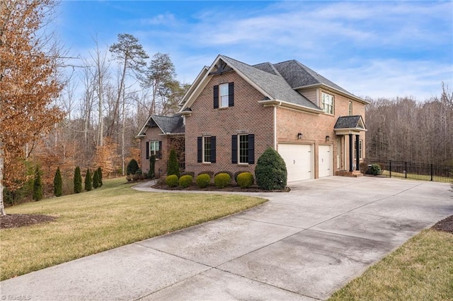 view of front of home with driveway, brick siding, an attached garage, fence, and a front yard