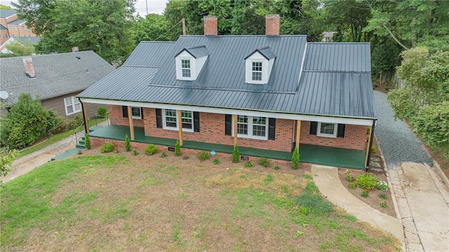 cape cod-style house with a front lawn