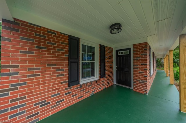 view of exterior entry with a porch