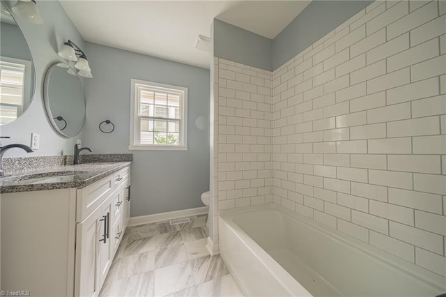 full bathroom with vanity, toilet, and tiled shower / bath combo