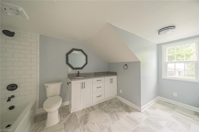 full bathroom with vanity, tiled shower / bath, vaulted ceiling, and toilet