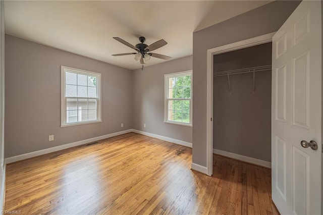 unfurnished bedroom with ceiling fan, light hardwood / wood-style floors, and a closet