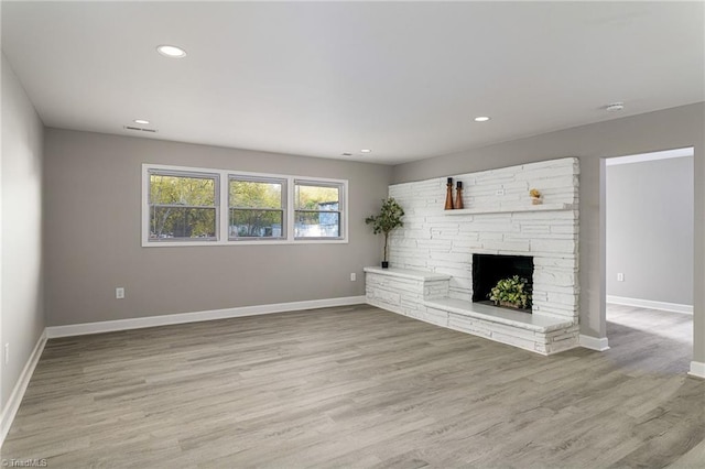 5515 Bethania Rd, Pfafftown, NC 27040 - unfurnished living room featuring light wood-style flooring, recessed lighting, and a fireplace