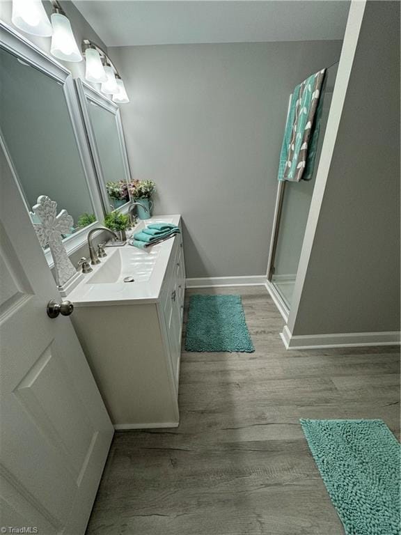 5515 Bethania Rd, Pfafftown, NC 27040 - full bath featuring wood finished floors, double vanity, and a stall shower