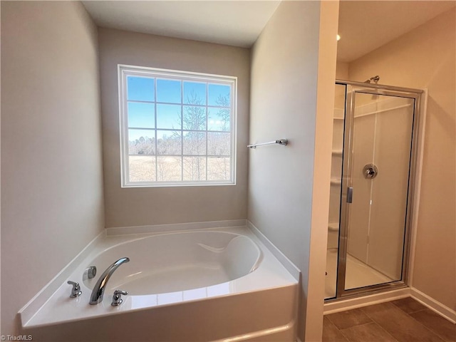 bathroom with a shower stall and a bath