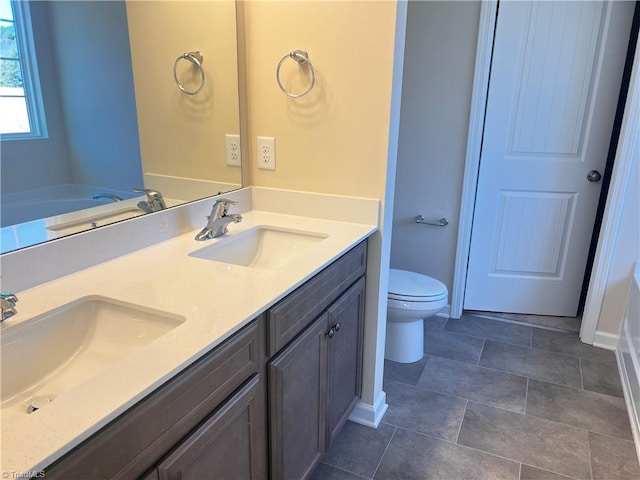 bathroom featuring a sink, toilet, and double vanity