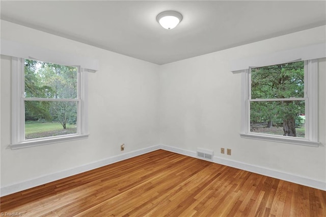 spare room with hardwood / wood-style flooring