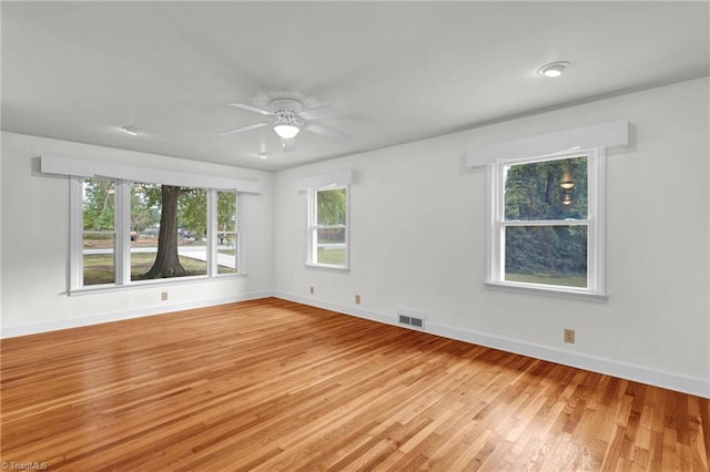 empty room with light hardwood / wood-style flooring and ceiling fan