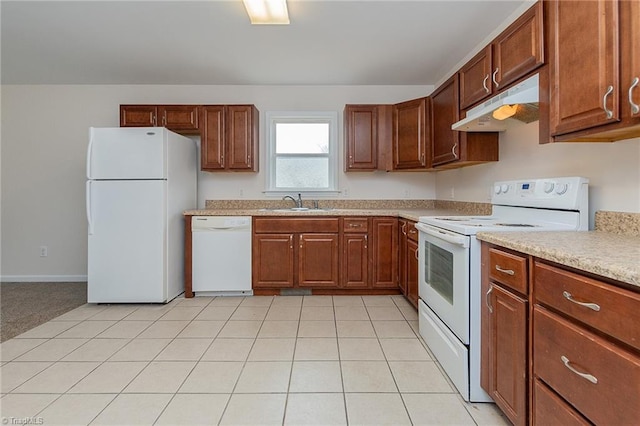 kitchen featuring under cabinet range hood, a sink, white appliances, light tile patterned flooring, and light countertops