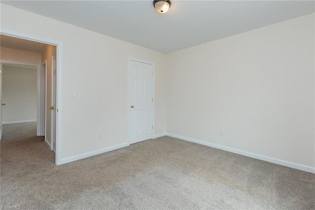 unfurnished bedroom featuring baseboards and carpet floors