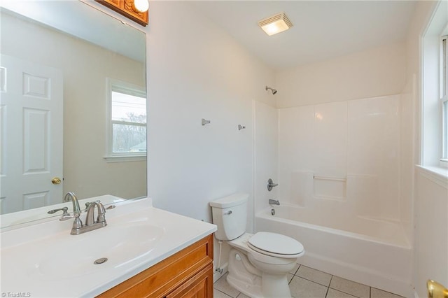 bathroom featuring bathing tub / shower combination, toilet, vanity, and tile patterned flooring