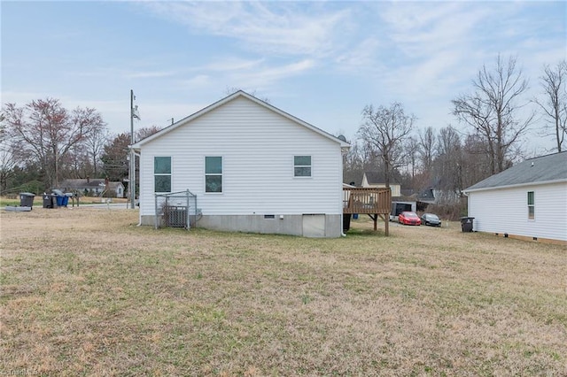 back of property with a lawn and a wooden deck