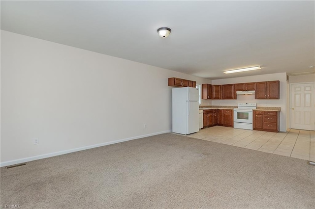 kitchen featuring light carpet, under cabinet range hood, white appliances, light countertops, and baseboards